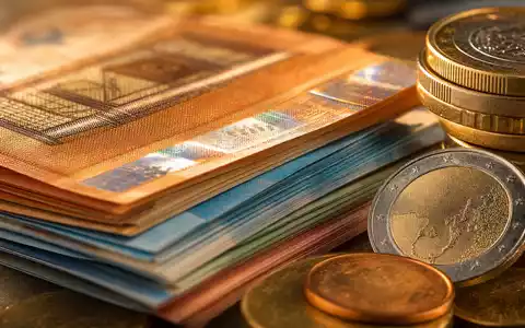 Makroaufnahme von Euro-Banknoten und Münzen veranschaulicht Kerngeschäft der internationalen Großbank BBVA (Banco Bilbao) ISIN ES0113211835 - Foto: THN