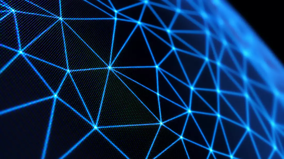 Macro photograph of glowing blue polygon wireframe mesh triangles on dark monitor screen