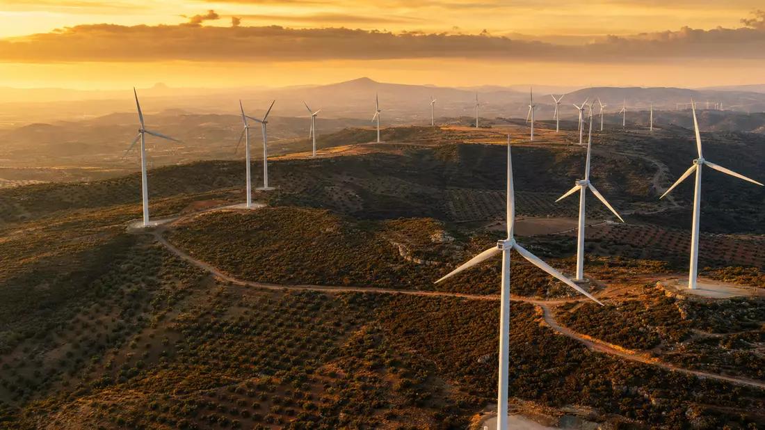 Fotorealistischer Windpark in iberischer Hügellandschaft bei goldener Abendsonne, EDP Renováveis