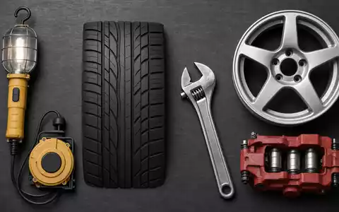 Michelin FR0000120321 Werkstatt zeigt Flatlay mit Reifenprofil-Schablone, Schraubenschlüssel, Felge, Bremssattel und Lampe - Foto: THN