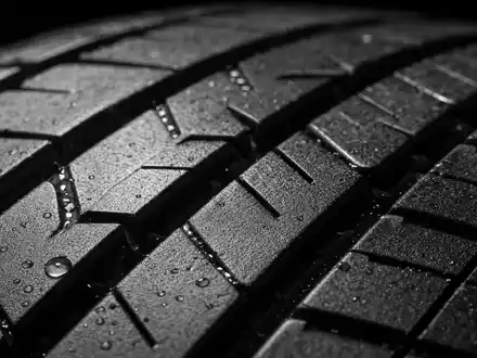 Michelin FR0000120321 Material zeigt extreme Makroaufnahme Reifenlauffläche mit nassen Rillen und Gummitextur - Foto: THN
