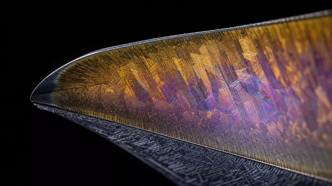 Extreme macro of turbine blade edge showing titanium alloy and gold thermal barrier coating