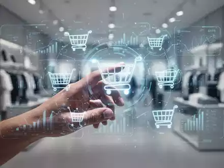 Eine stilisierte menschliche Hand interagiert mit einer holographischen Schnittstelle, die Finanzdaten und Einkaufswagen-Symbole anzeigt. - Foto: über boerse-global.de