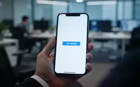 Eine Hand hält ein Smartphone mit leerem Bildschirm, symbolisiert ein technisches Problem mit einer Meeting-App im Büro. - Foto: über boerse-global.de