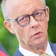 Kanzler Merz: «Sie müssen nicht am ersten Tag in die Arztpraxis.»  - Bild: Michael Kappeler/dpa
