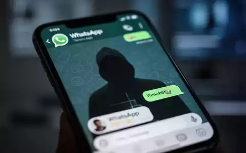 Ein Smartphone-Bildschirm zeigt eine WhatsApp-Konversation mit einer verschwommenen Reflexion, die Identitätsdiebstahl darstellt. - Foto: über boerse-global.de