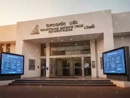 Moderner Gerichtseingang in Lomé, Togo, mit digitalen Bildschirmen und dezentem Netzlinien-Overlay. - Foto: über boerse-global.de