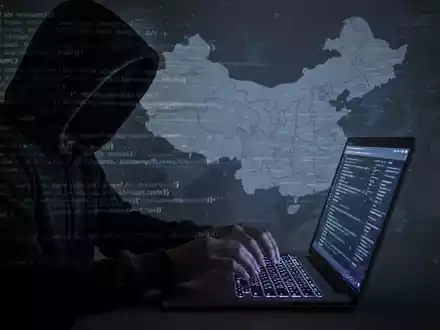 Schattenfigur tippt auf Laptop, Codezeilen und China-Karte im Hintergrund, symbolisiert Cyberbedrohungen. - Foto: über boerse-global.de