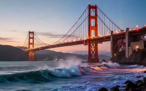Die Golden Gate Bridge in der Dämmerung, mit animierten Wellen darunter und Fahrzeuglichtern, die über die Brücke ziehen. - Foto: über boerse-global.de
