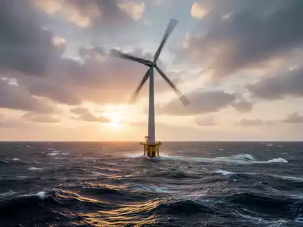 Eine einzelne, moderne Offshore-Windkraftanlage im Meer bei Sonnenaufgang, ihre Rotorblätter verschwimmen vor dramatischem Himmel. - Foto: über boerse-global.de