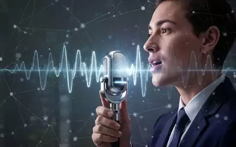 Eine Person spricht in ein futuristisches Mikrofon, mit einer leuchtenden Wellenform, die KI-Sprachtechnologie und globale Kommunikation darstellt. - Foto: über boerse-global.de