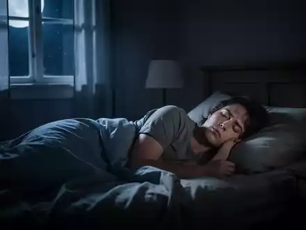 Eine Person liegt wach im Bett, das Zimmer ist dunkel, mit Mondlicht, das durch ein Fenster fällt. - Foto: über boerse-global.de