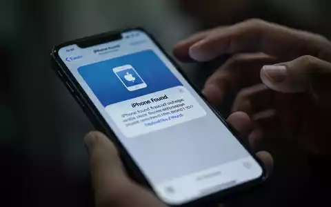Nahaufnahme eines Smartphones, das eine betrügerische Phishing-Nachricht anzeigt, mit unscharfen Händen im Hintergrund. - Foto: über boerse-global.de