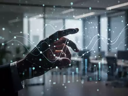 Eine stilisierte menschliche Hand interagiert mit einem holografischen Interface, das abstrakte Datenpunkte und Linien anzeigt. - Foto: über boerse-global.de