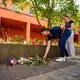 Menschen kommen vorbei und legen Blumen ab. - Bild: Andreas Arnold/dpa