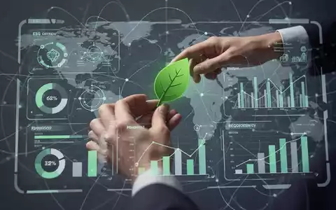Eine Hand platziert ein grünes Blatt-Symbol auf einem digitalen Dashboard mit ESG-Kennzahlen und Datenvisualisierungen. - Foto: über boerse-global.de