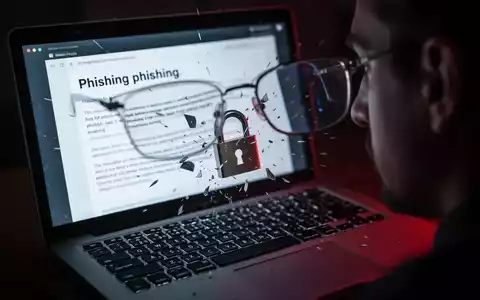 Nahaufnahme eines Laptop-Bildschirms mit Phishing-E-Mail, zerbrechendes Vorhängeschloss-Symbol symbolisiert Datenleck. - Foto: über boerse-global.de