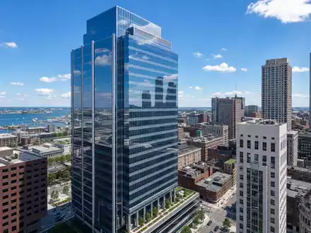 Boston Properties US1011371077 zeigt einen modernen Glasturm im Bostoner Finanzviertel mit Hafenblick - Foto: THN