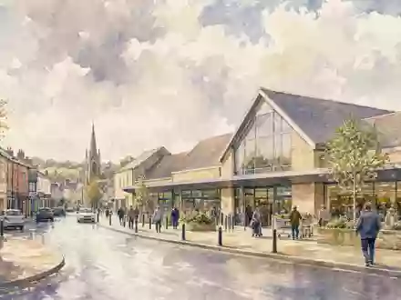 Tesco plc (ISIN GB00BLGZ9862) prägt britische Einkaufsstraßen, künstlerisch dargestellt als malerische Aquarell-Ansicht - Foto: THN