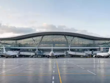 International Consolidated Airlines Group S.A. (ES0177542018): modernes Architektur-Render eines Flughafenterminals mit geparkten Flugzeugen gezeigt - Foto: THN
