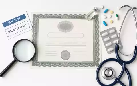 Flatlay-Arrangement mit Aktienzertifikat und ISIN-Karte symbolisiert Aktie von Johnson & Johnson, ISIN US4781601046, im Pharmasektor - Foto: THN