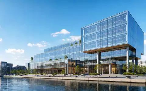 Jyske Bank A/S (DK0010307958) symbolisiert durch ein modernes Glas-Bürogebäude im skandinavischen Finanzdistrikt am Wasser - Foto: THN