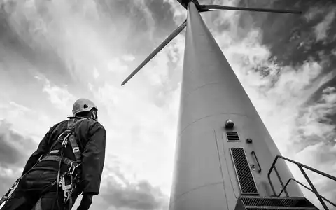 AES Corp. US00130H1059 black and white reportage technician inspecting wind turbine infrastructure - Foto: THN