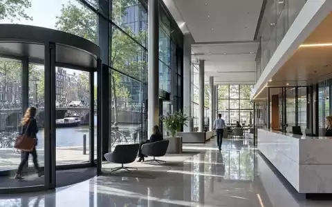 ABN AMRO Bank N.V. mit ISIN NL0011540547 zeigt eine moderne Bankfiliale mit Glasfassade in Amsterdam - Foto: THN