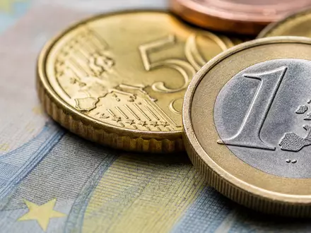 ABN AMRO Bank N.V., ISIN NL0011540547, zeigt eine Makroaufnahme von Euro-Münzen und Banknotenstruktur - Foto: THN