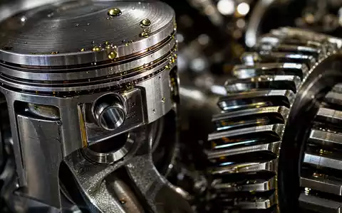 Stellantis N.V. (NL00150001Q9) zeigt eine Makroaufnahme von Motorkolben und Zahnrädern mit glänzenden Öltropfen im Detail - Foto: THN