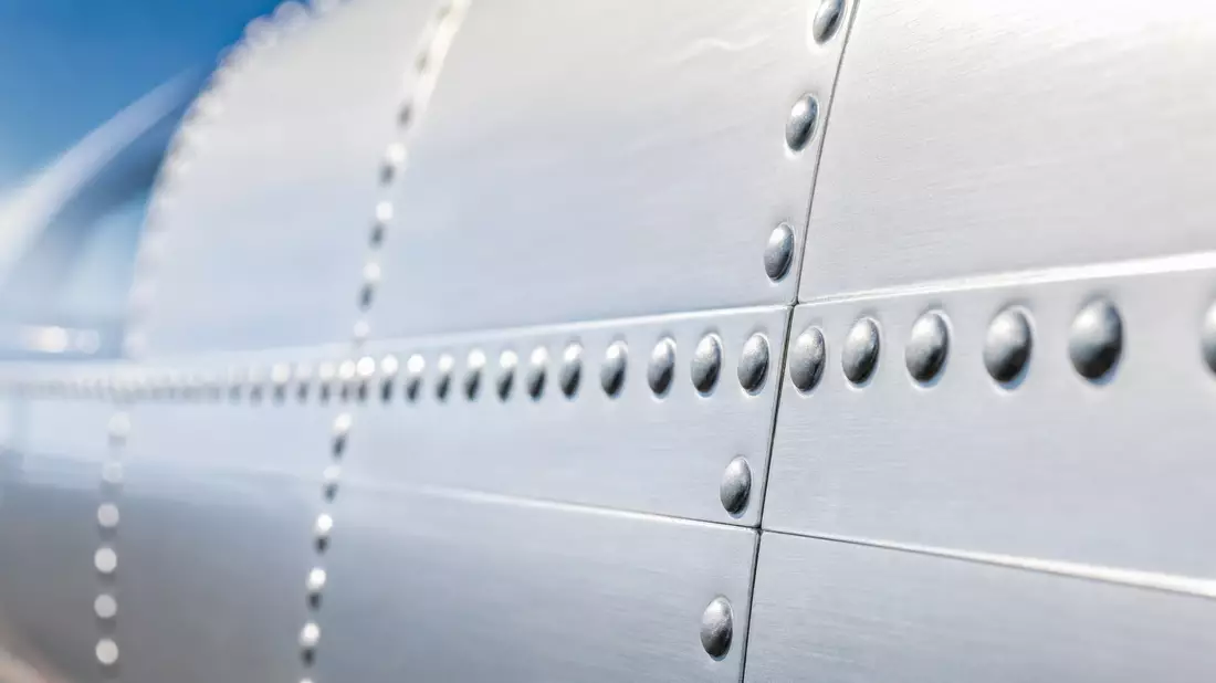 Extreme Makroaufnahme einer polierten Flugzeug-Aluminiumhaut mit Nieten