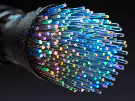 Liberty Broadband (US5303071071): Makroaufnahme leuchtender Glasfaserenden zeigt die technische Basis der Breitbandbranche - Foto: THN