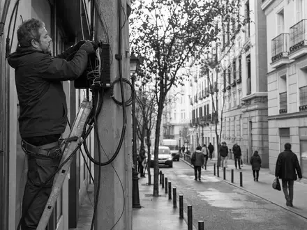 Telefónica S.A. (ISIN ES0178430E18) sichert Netzinfrastruktur, während Techniker Glasfaserkabel in Madrider Straßen installieren und warten - Foto: THN