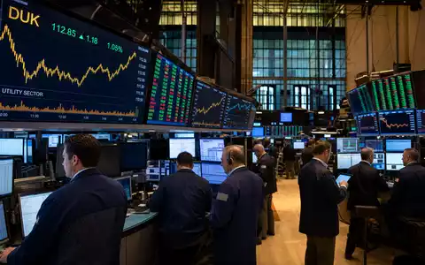Duke Energy Aktie US26441C2044 auf belebtem NYSE-Börsenparkett mit DUK-Kursanzeige auf großen LED-Bildschirmen - Foto: THN