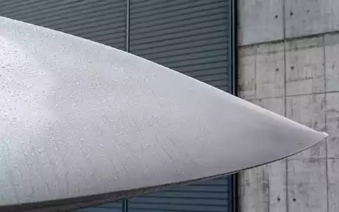 Wallenstam AB (ISIN SE0017780137) engagiert sich in Windkraft, hier als Makroaufnahme einer nassen Rotorblattoberfläche gezeigt - Foto: THN