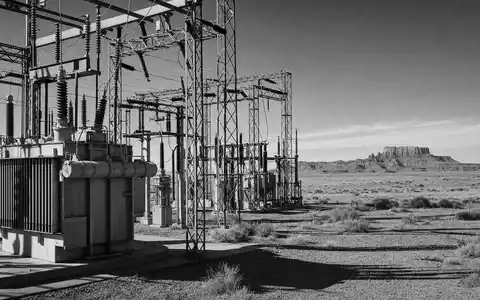 Pinnacle West Capital US7234841010 zeigt ein dokumentarisches Schwarzweißbild eines Umspannwerks in der weiten Wüste Arizonas - Foto: THN