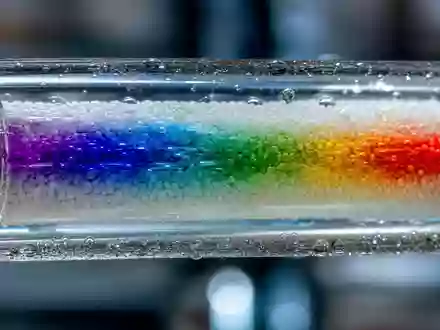 Waters Corporation (ISIN US9418481035) zeigt eine Makroaufnahme einer farbigen Chromatographiesäule mit fließender Probenflüssigkeit - Foto: THN
