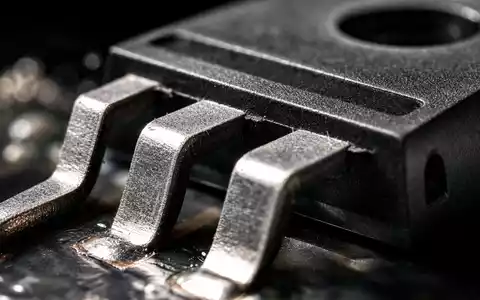 ON Semiconductor US6821891035 zeigt eine detaillierte Makroaufnahme eines Leistungshalbleiter-Gehäuses mit glänzenden Metallanschlüssen und Lötpins - Foto: THN
