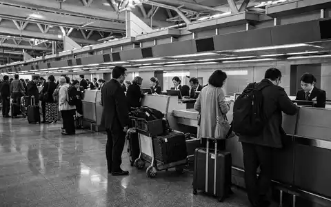 Amadeus IT Group ES0109067019 black and white reportage photo airline check-in counter agents - Foto: THN