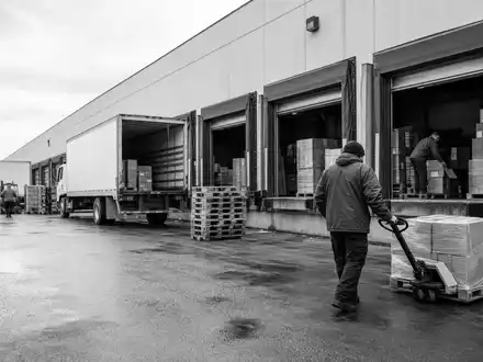 SchwarzweiĂ-Reportage zeigt B&M European Value Retail S.A. GB0001826634 mit Lieferverkehr am Lager eines Einzelhandelsunternehmens - Foto: THN