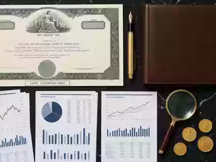 Ameriprise Financial Inc. US03076C1062 Flatlay Stillleben mit Aktienzertifikat FĂĽllfeder Kompass Lupe und GoldmĂĽnzen - Foto: THN