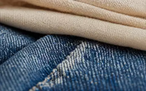 Makroaufnahme von Textilgewebe illustriert das Warensortiment der Branche von Target Corp., ISIN US87612E1064, in Denimstruktur - Foto: THN