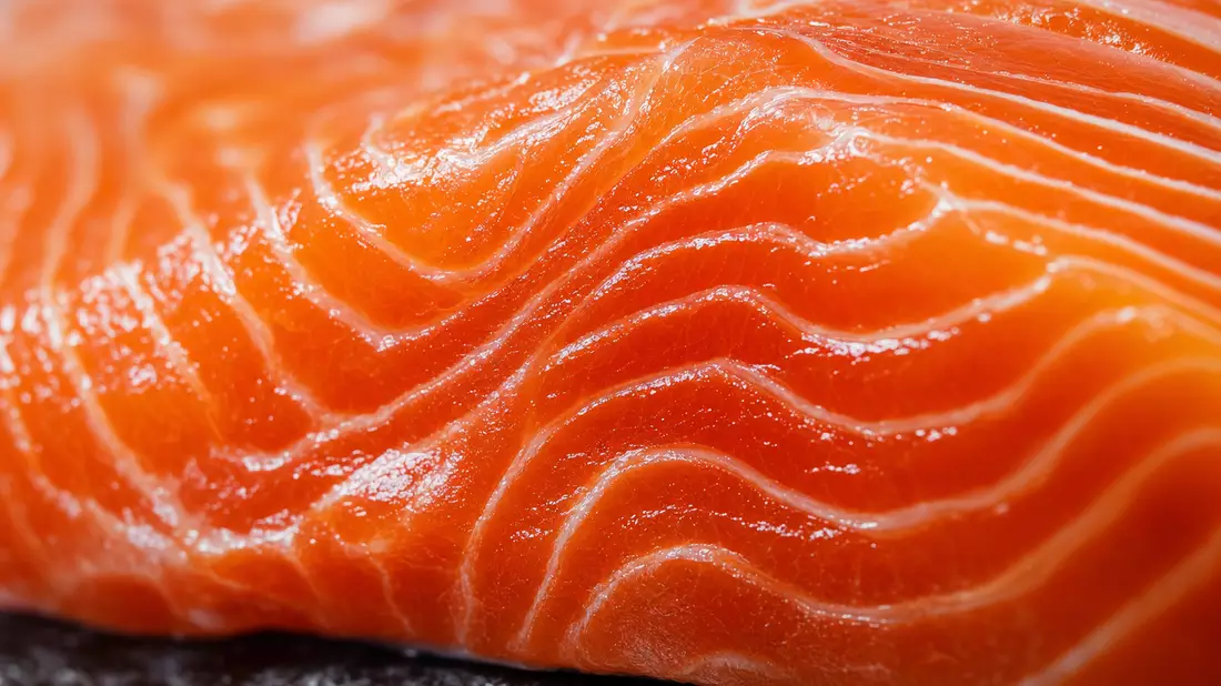 Extreme Nahaufnahme der marmorierten Textur eines frischen orangefarbenen Lachsfilets
