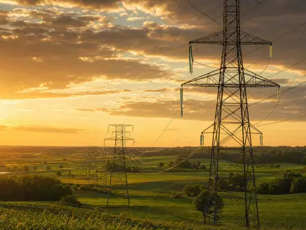 Ameren Corp. US0236081024 photorealistic transmission towers across Missouri farmland at golden hour - Foto: THN