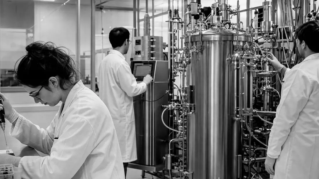 Schwarzweissfoto von Forschern in einem industriellen Biotechnologie-Labor