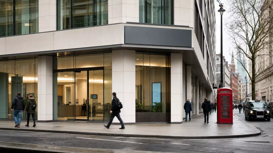 Moderne Bankfiliale in einer britischen Innenstadt mit Passanten und schwarzem Taxi
