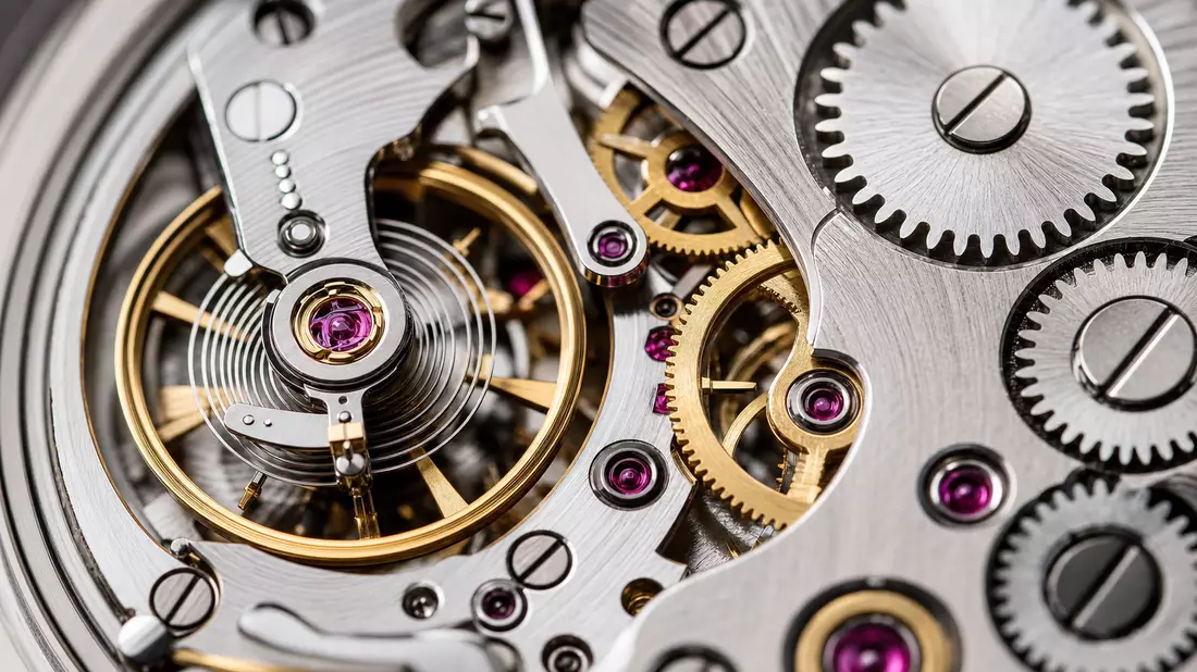 Makroaufnahme eines mechanischen Uhrwerks mit Zahnrädern und Rubinlagern