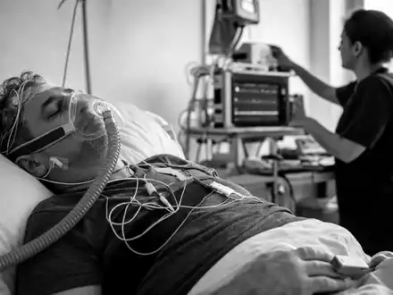ResMed Inc. (ISIN US7611521078): dokumentarische Schwarzweiß-Reportage zeigt einen Patienten mit Atemmaske im Schlaflabor - Foto: THN