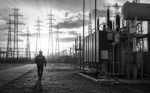Schwarzweiß-Reportagefoto dokumentiert Umspannwerk der Iberdrola S.A. (ISIN ES0144580Y14) mit Hochspannungsmasten im Gegenlicht - Foto: THN