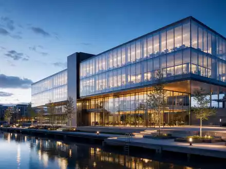 Architektur-Render visualisiert ein modernes gläsernes Bürohochhaus am Wasser, symbolisch für die Kesko Oyj Aktie FI0009000202 - Foto: THN